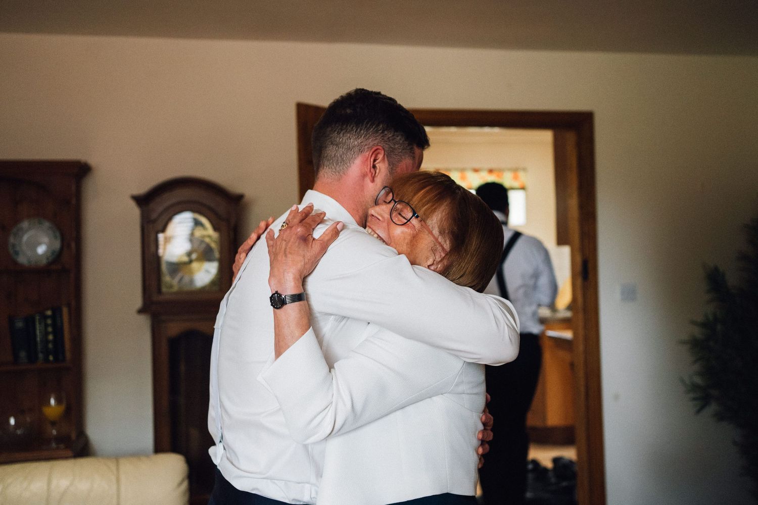A sequence of intimate wedding moments showing couples embracing and dancing in an indoor setting.