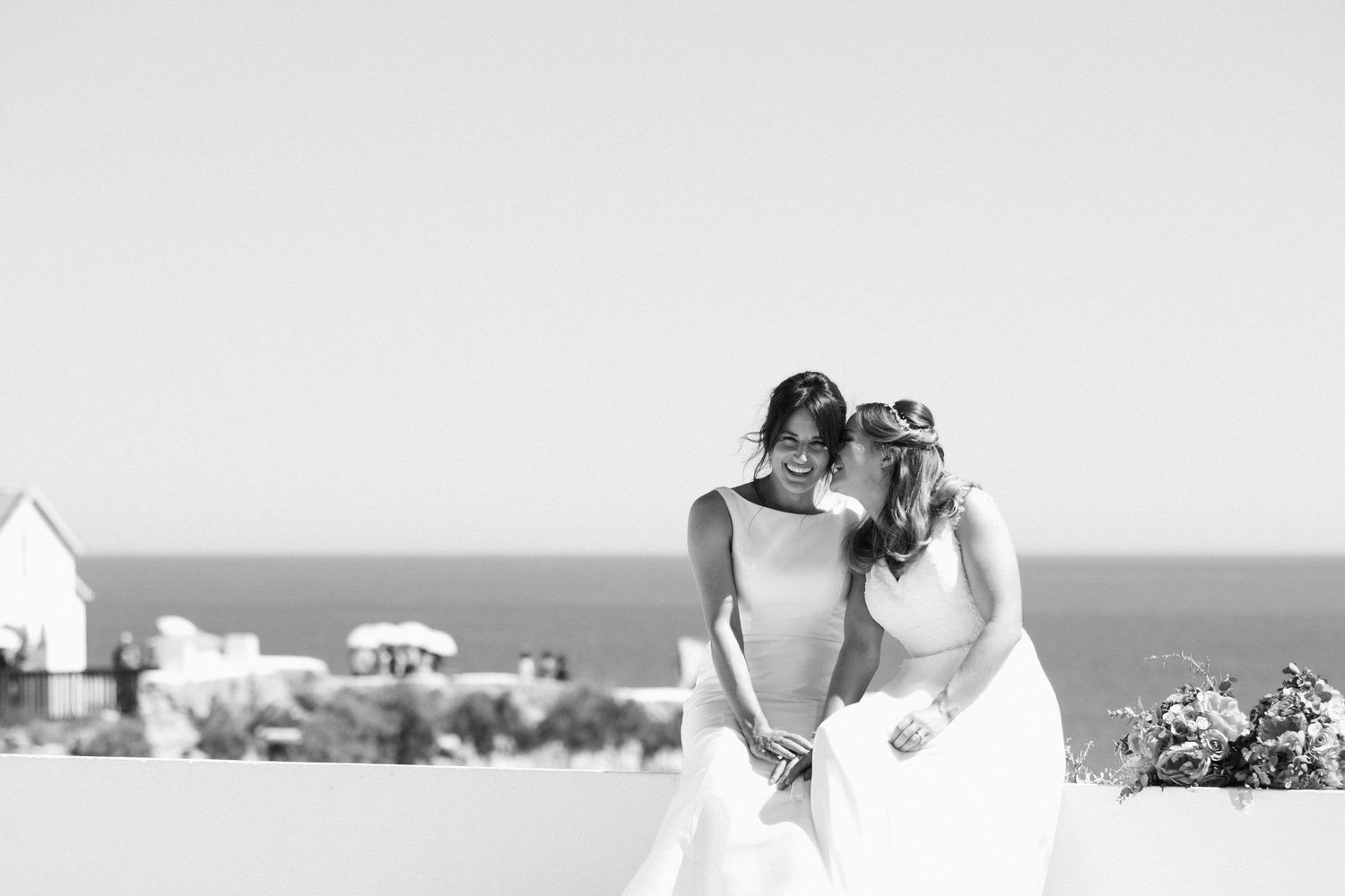 Scenic coastal wedding setup with white chapel and ocean views.