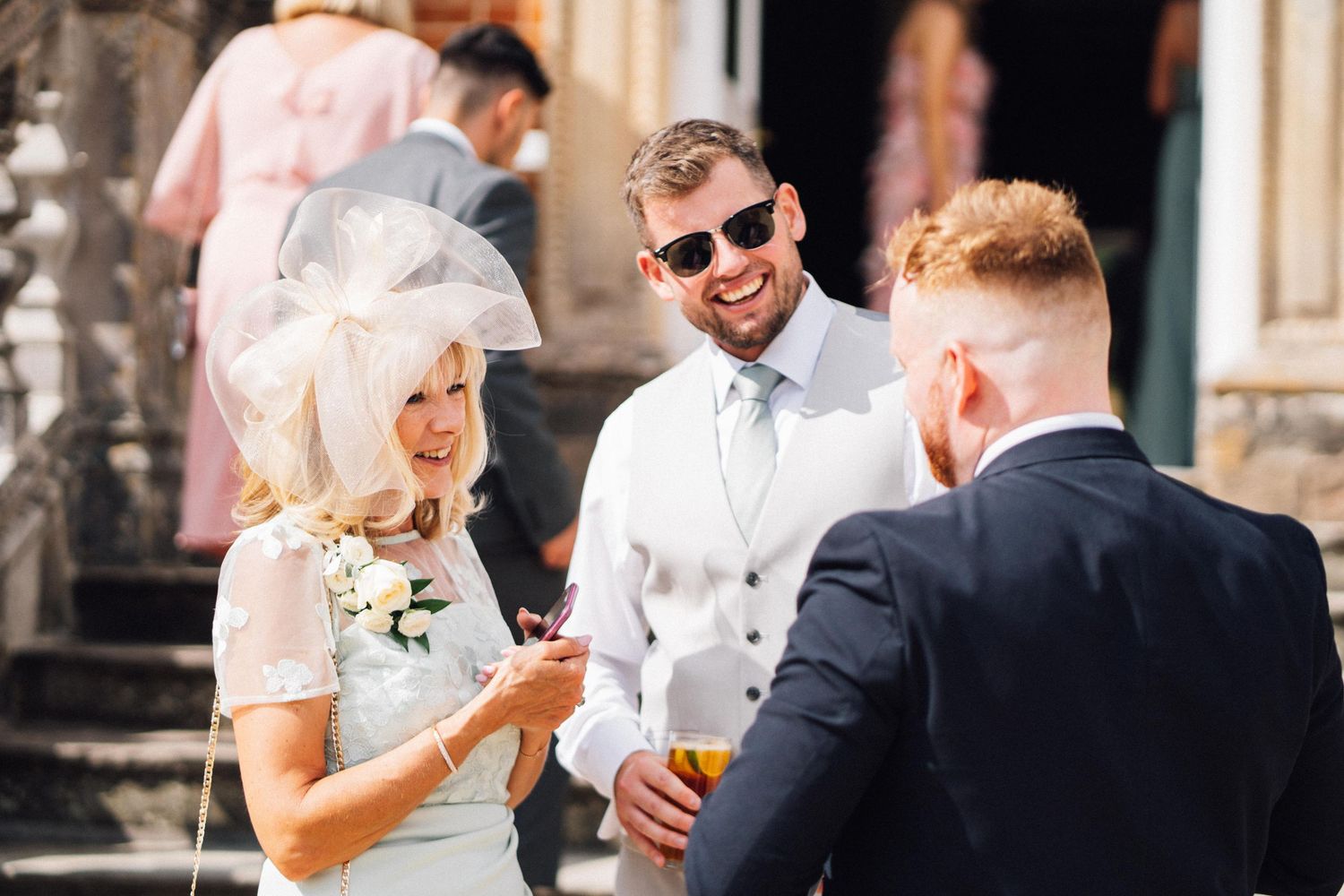 Guests enjoying drinks and conversation at an elegant wedding reception.