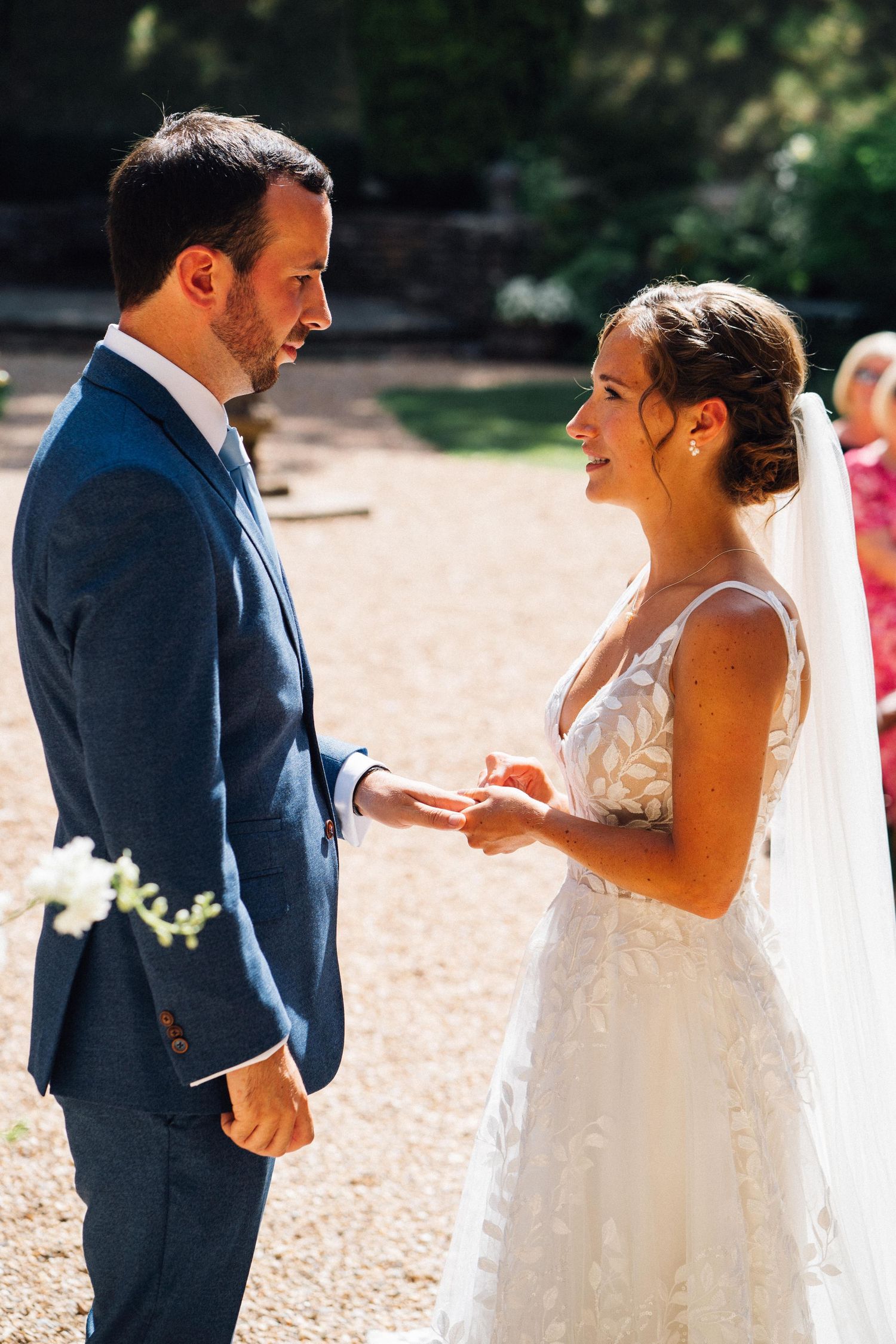 A series of candid wedding moments showing a couple exchanging rings during an outdoor ceremony.