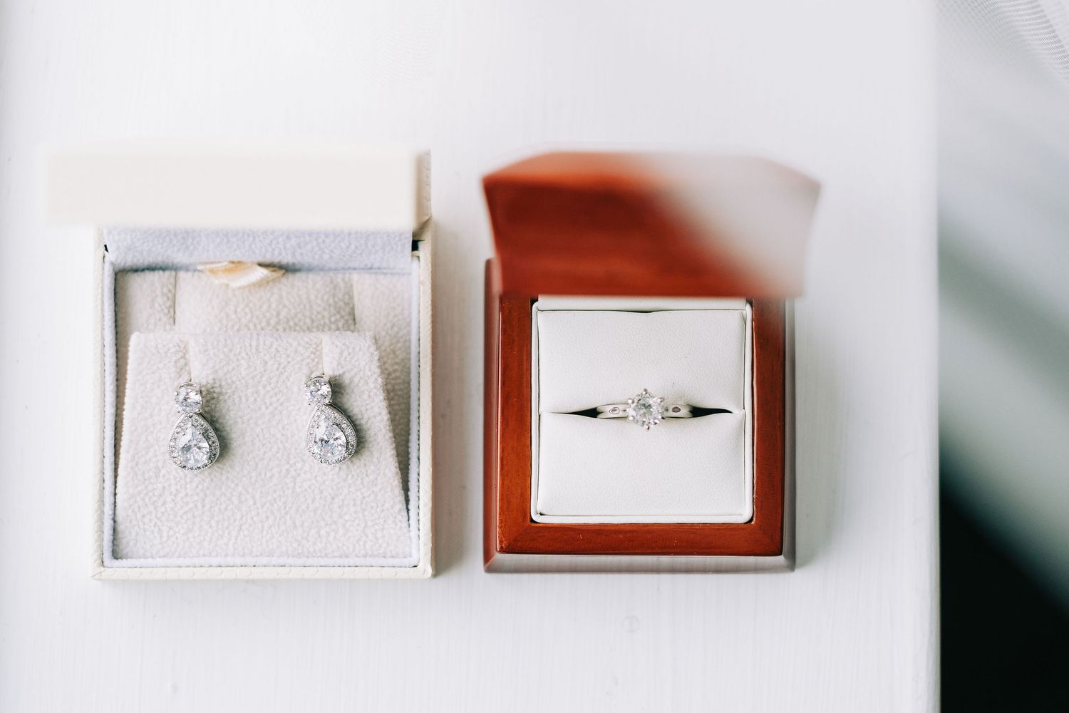 Wedding rings and jewelry arranged neatly on white display boxes.