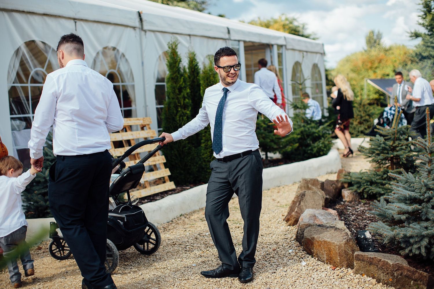 Wedding staff in white shirts preparing the outdoor venue space.