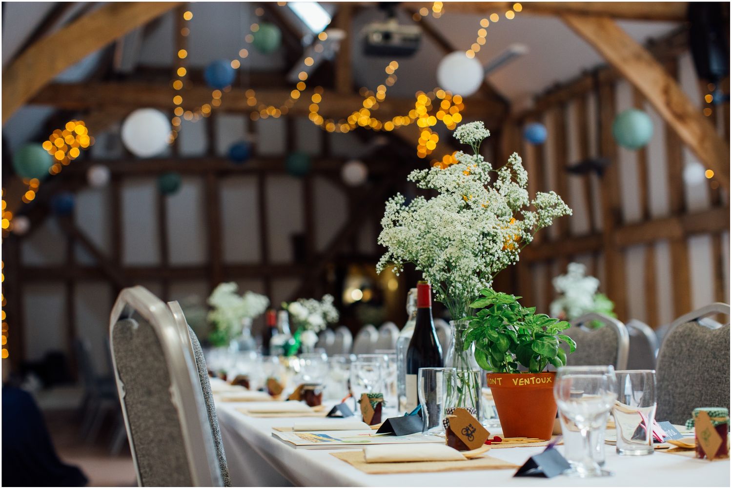Elegant wedding reception venue with twinkling lights and table settings.