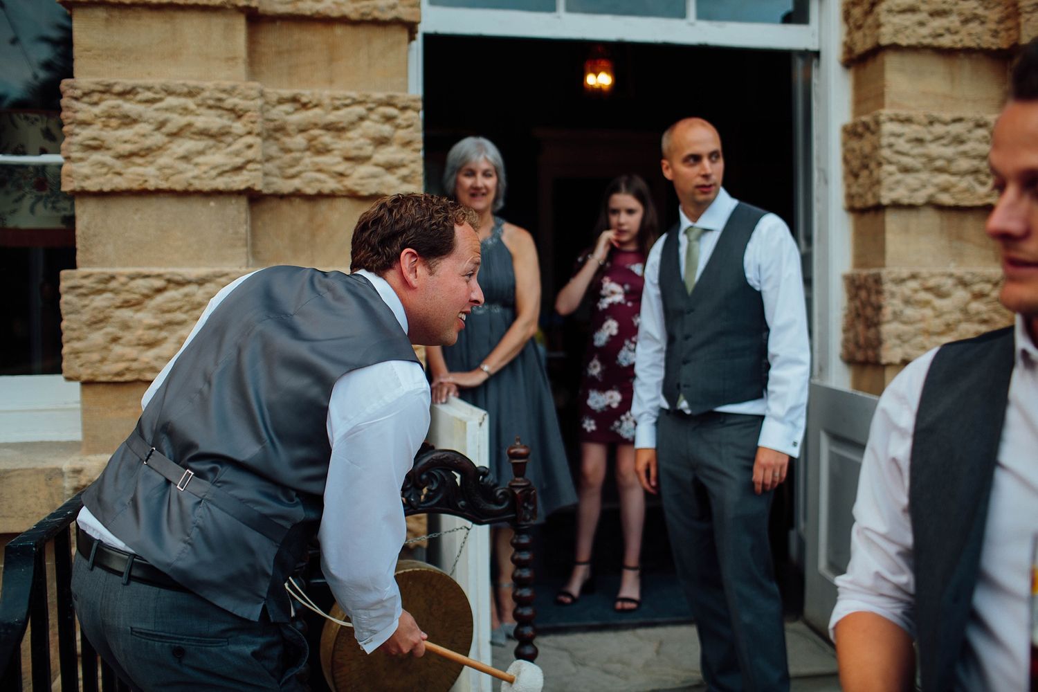 Person with camera crouching to take photos while others watch.