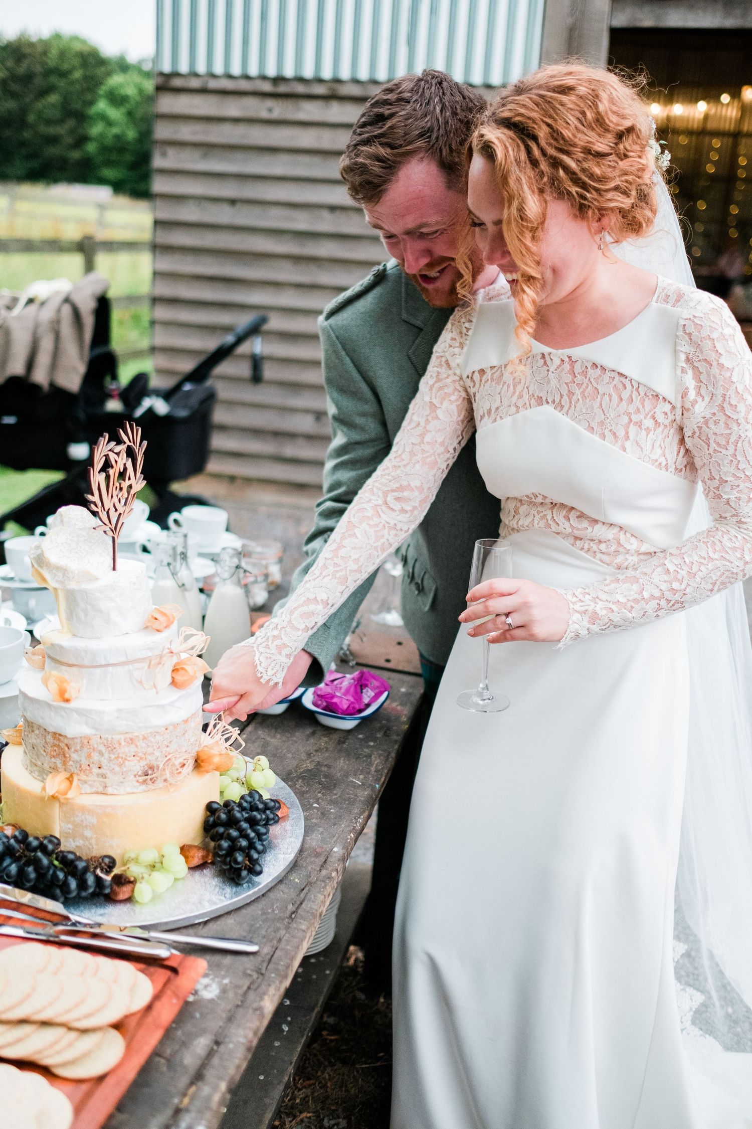 Newlyweds laughing together during their wedding cake cutting ceremony.