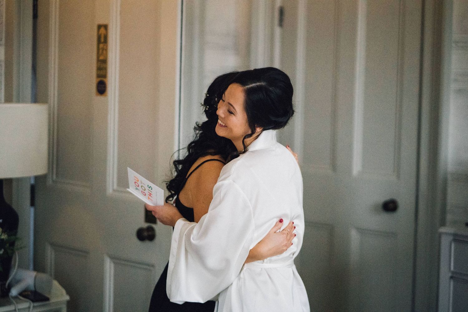 Emotional wedding day preparations captured in intimate black and white photography.