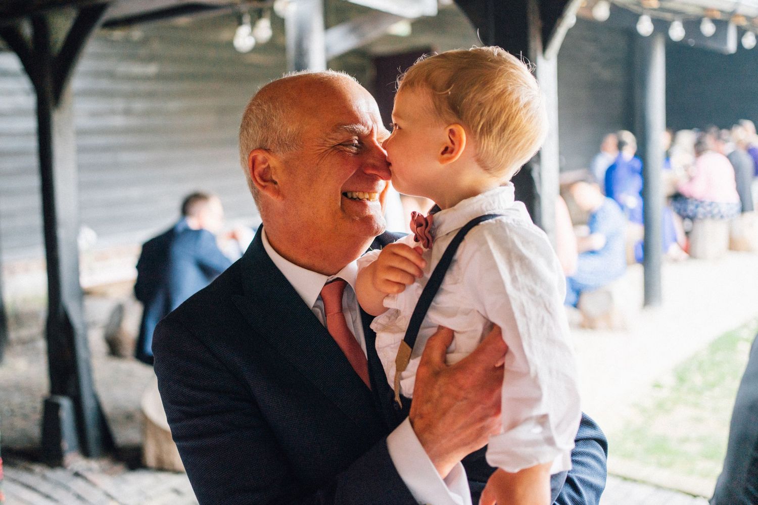 Sweet candid moments captured during wedding reception with guests interacting.