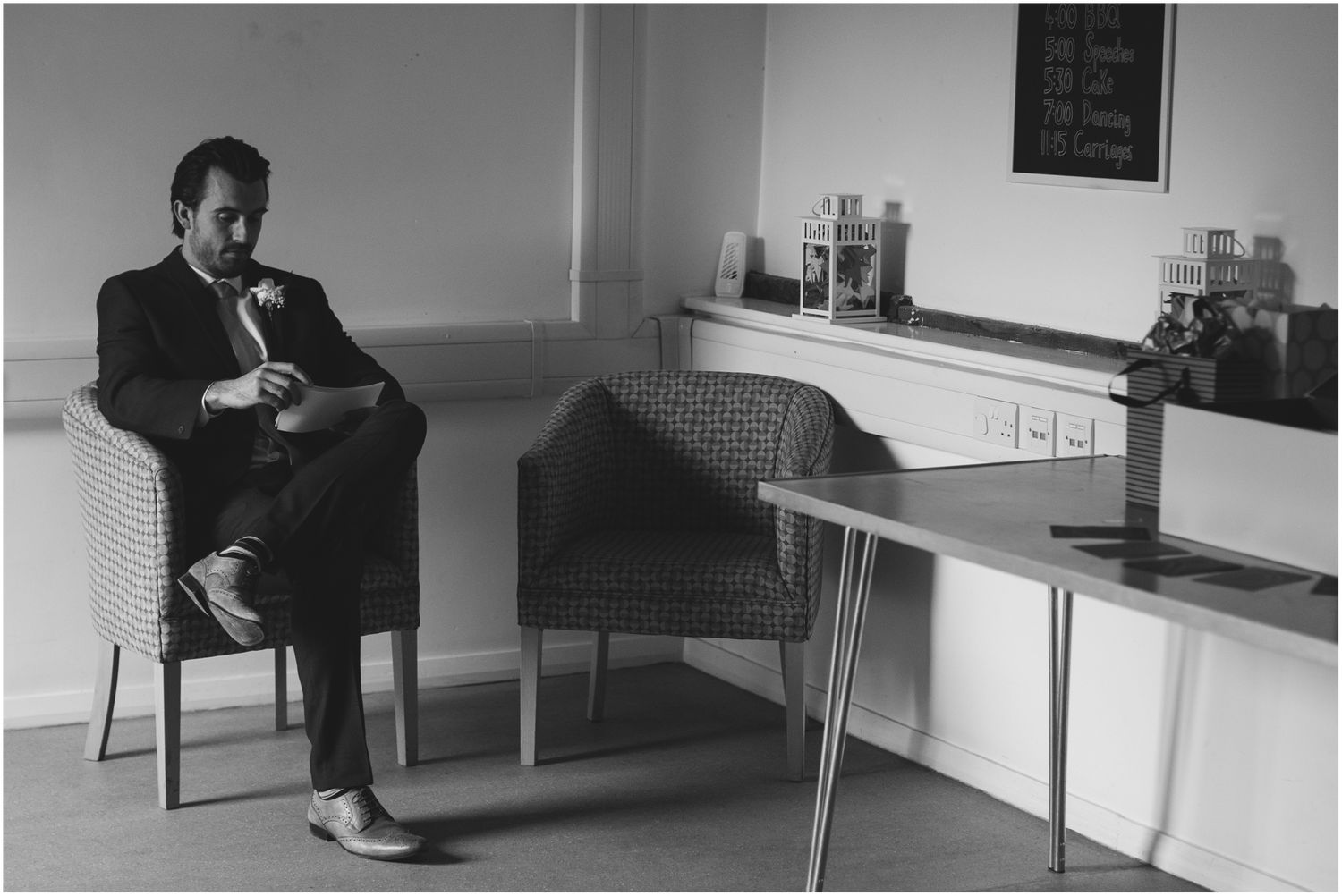 Black and white image of a modern office interior with minimalist furniture.