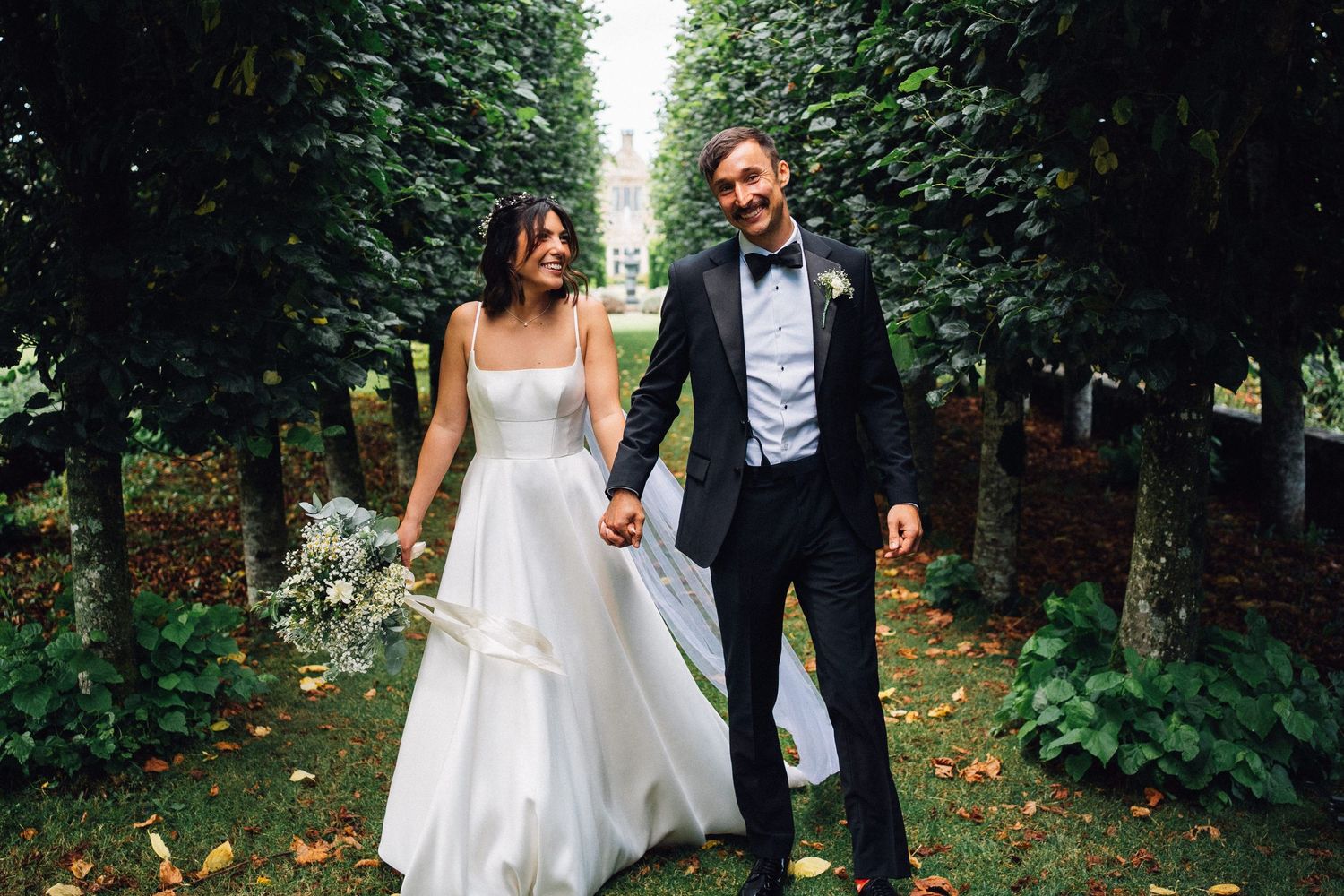 Romantic wedding photography in a lush green garden setting.