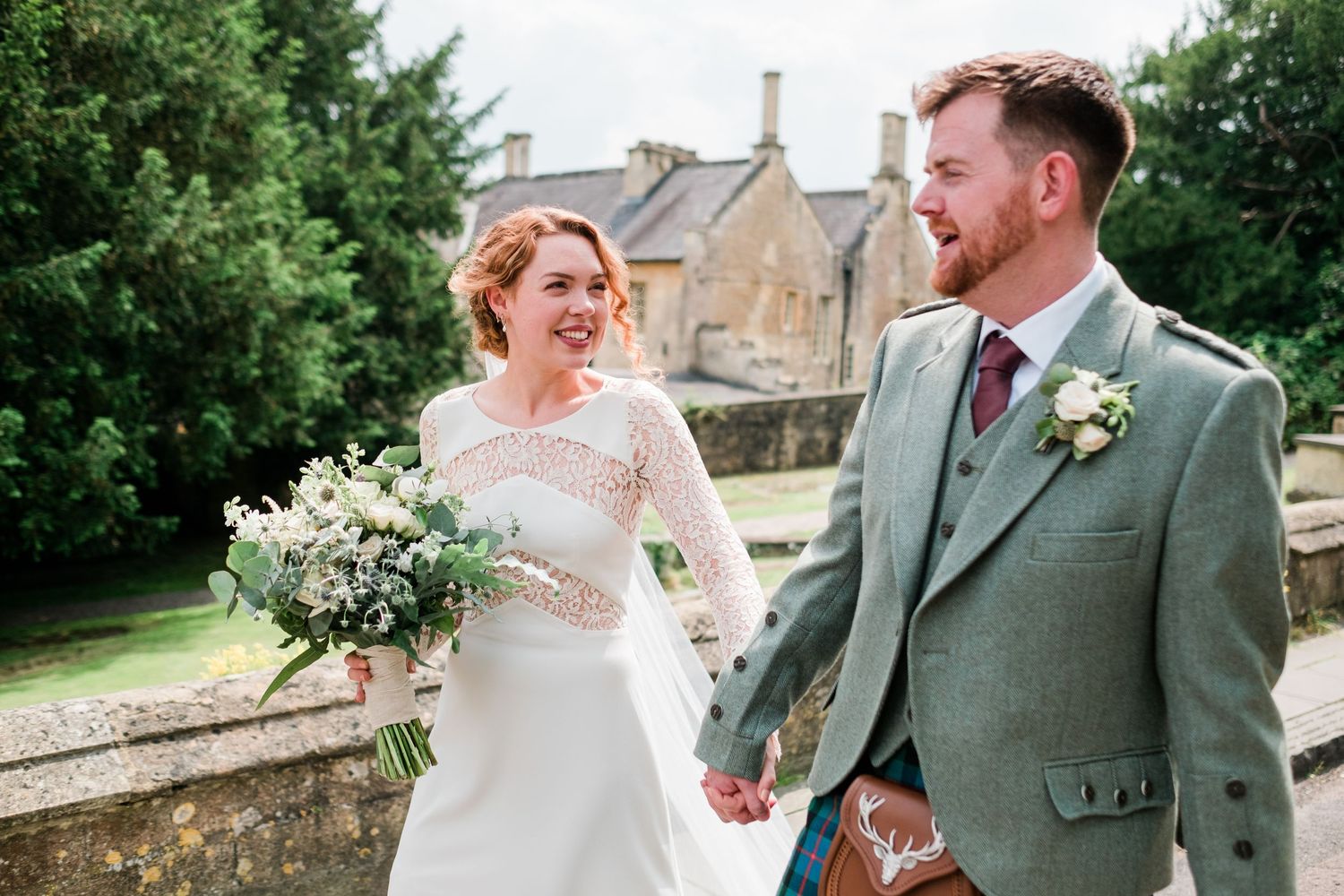 A couple sharing a candid moment together during their Scottish-themed wedding.