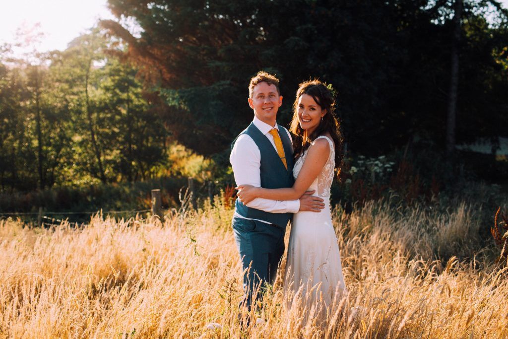 Intimate wedding portraits taken in warm evening light outdoors.