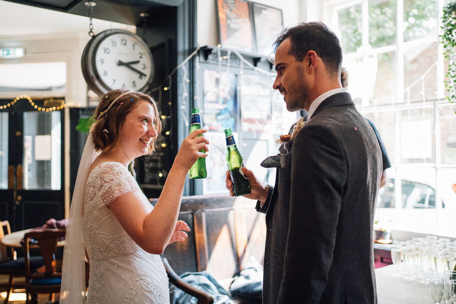 A series of candid wedding moments showing couples sharing drinks and toasting at their celebration.