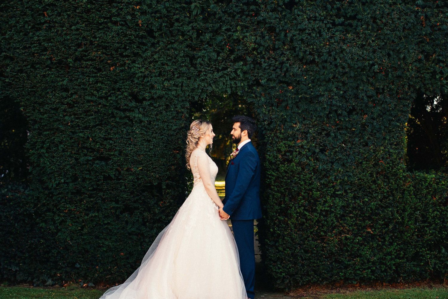 A bride and groom share a romantic dance during their wedding reception at an outdoor venue.
