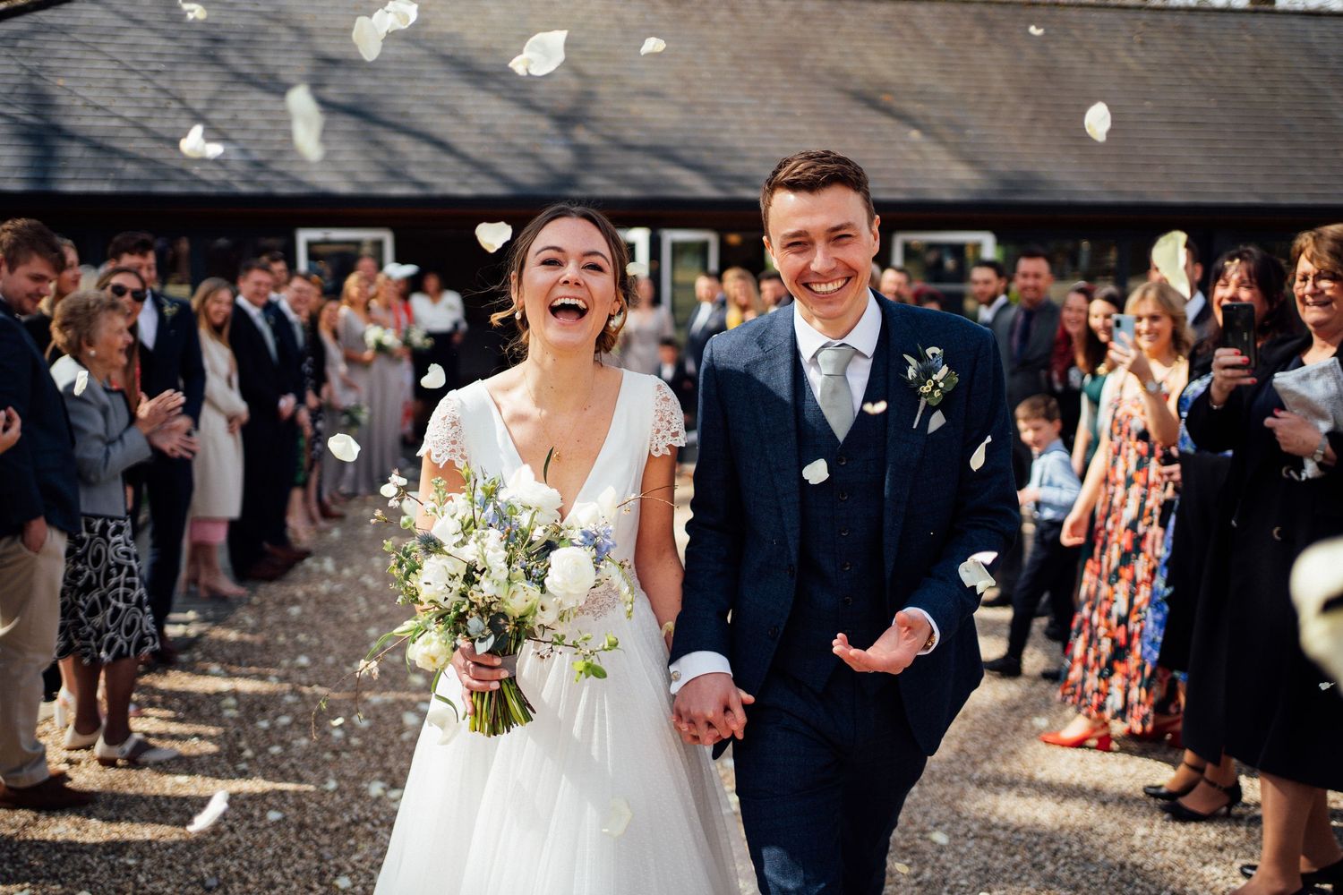 Couple laughing during confetti exit at Bristol Wedding
