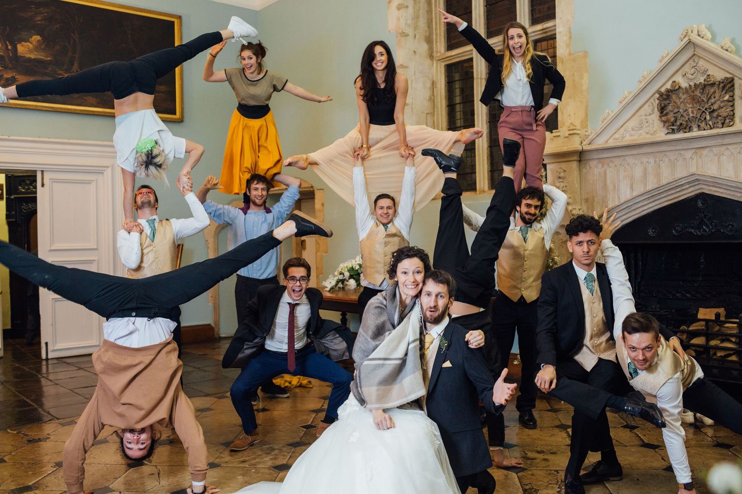 Wedding party members dancing and celebrating with energetic moves on the dance floor.