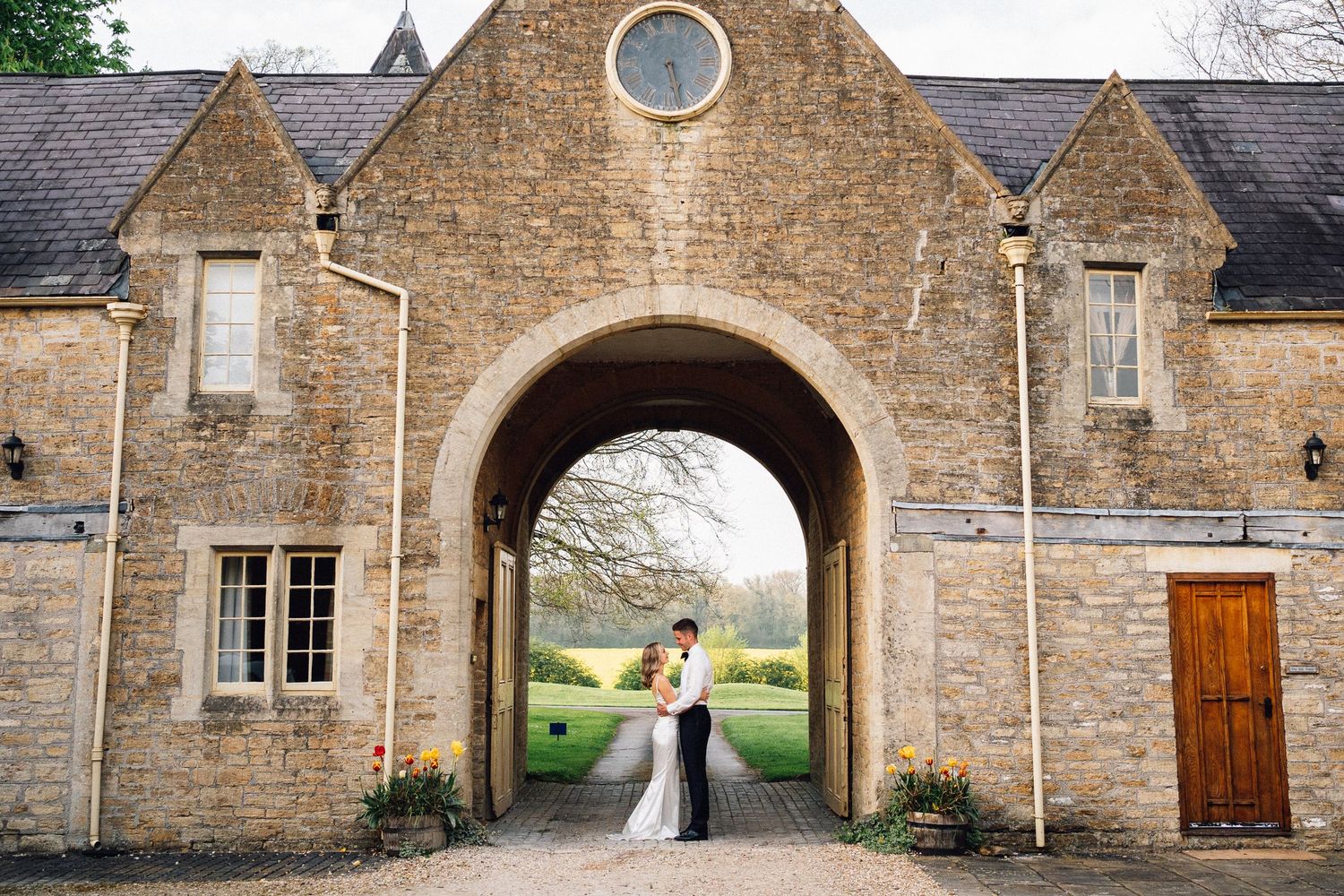 Stone archway entrance of a historic building with rustic architectural details.