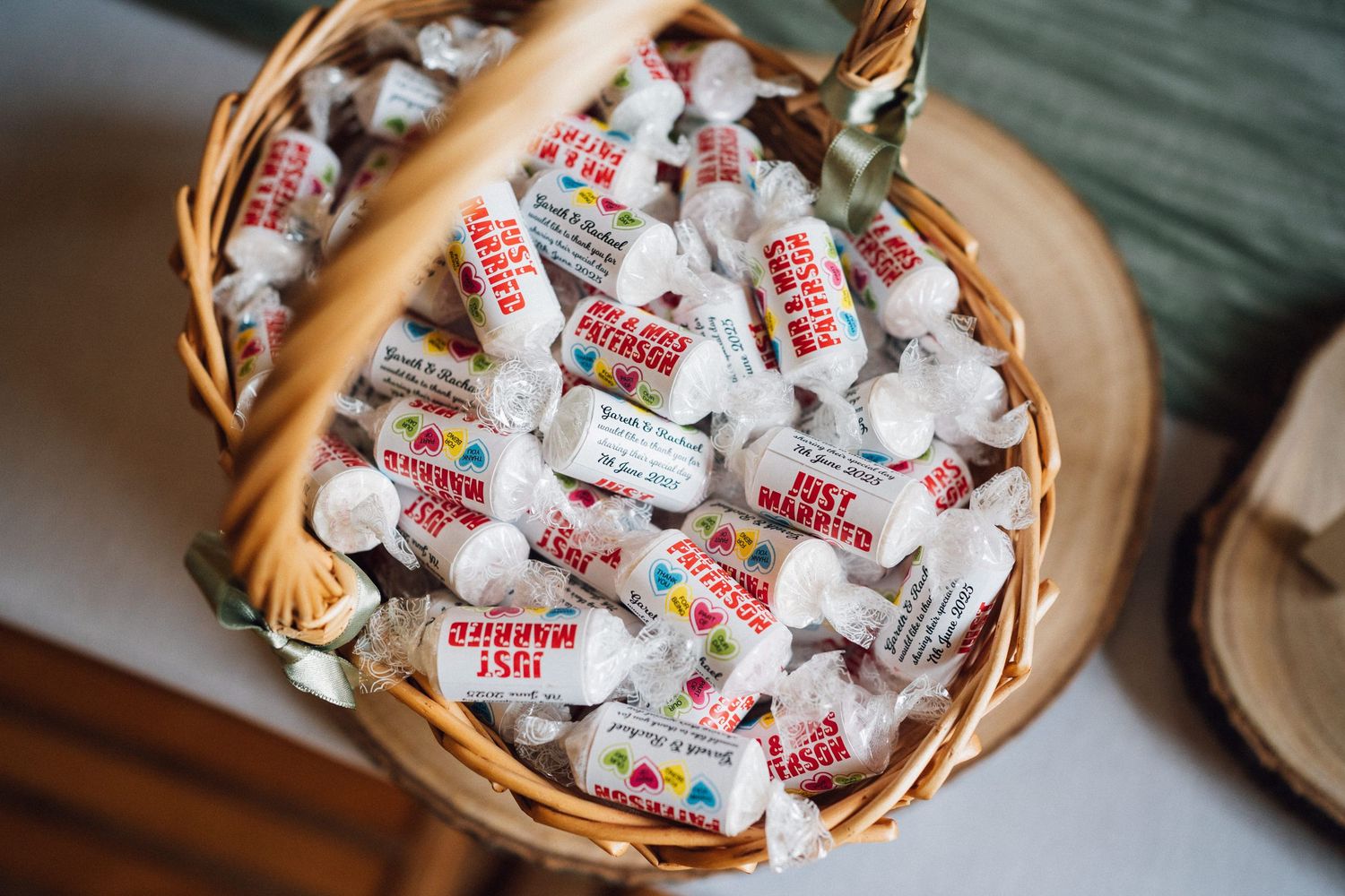 Woven basket filled with wrapped saltwater taffy candies in pink and white packaging.