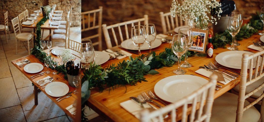 Rustic wooden reception tables decorated with delicate floral arrangements.