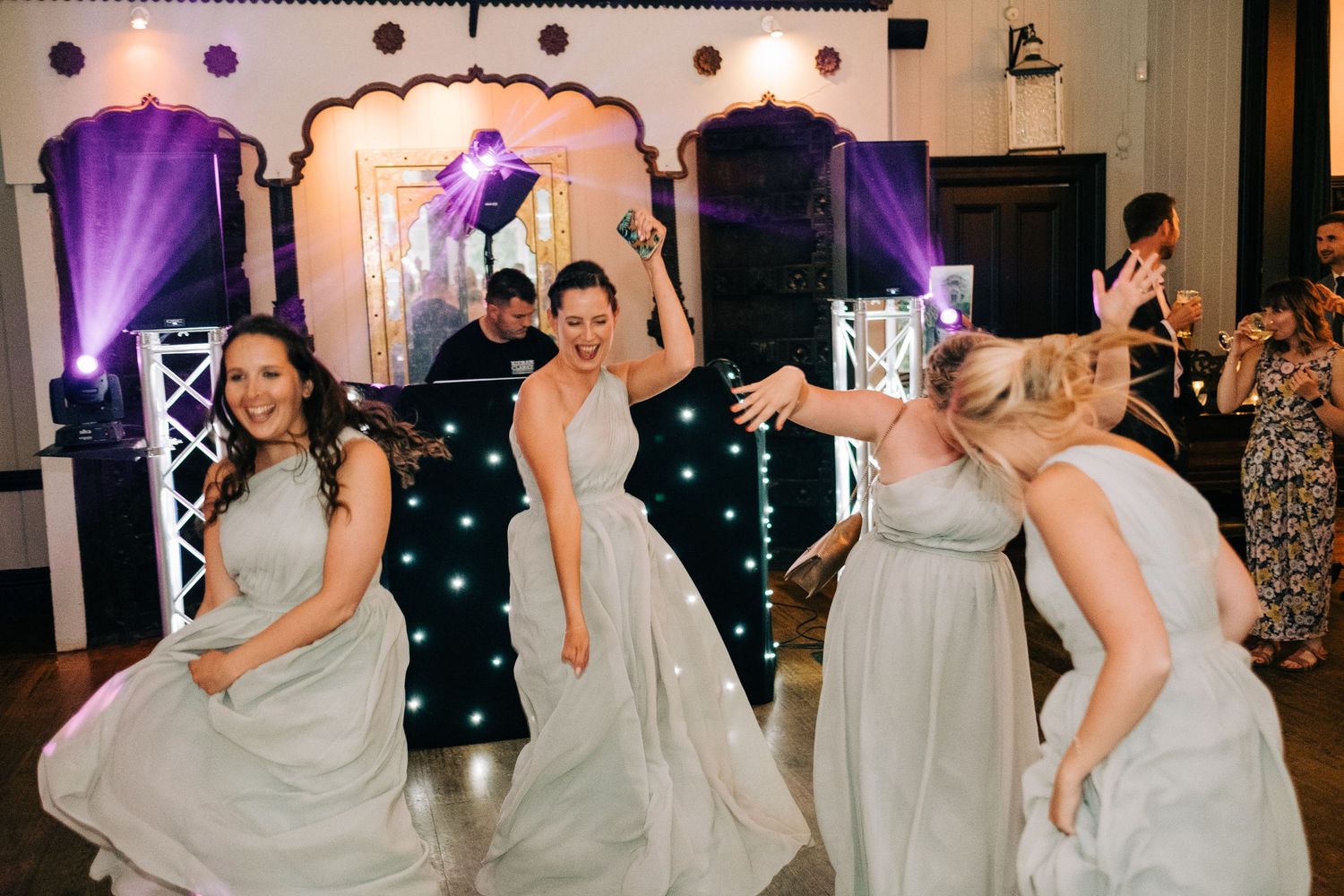 Wedding reception dance floor with festive lighting and celebration in progress.