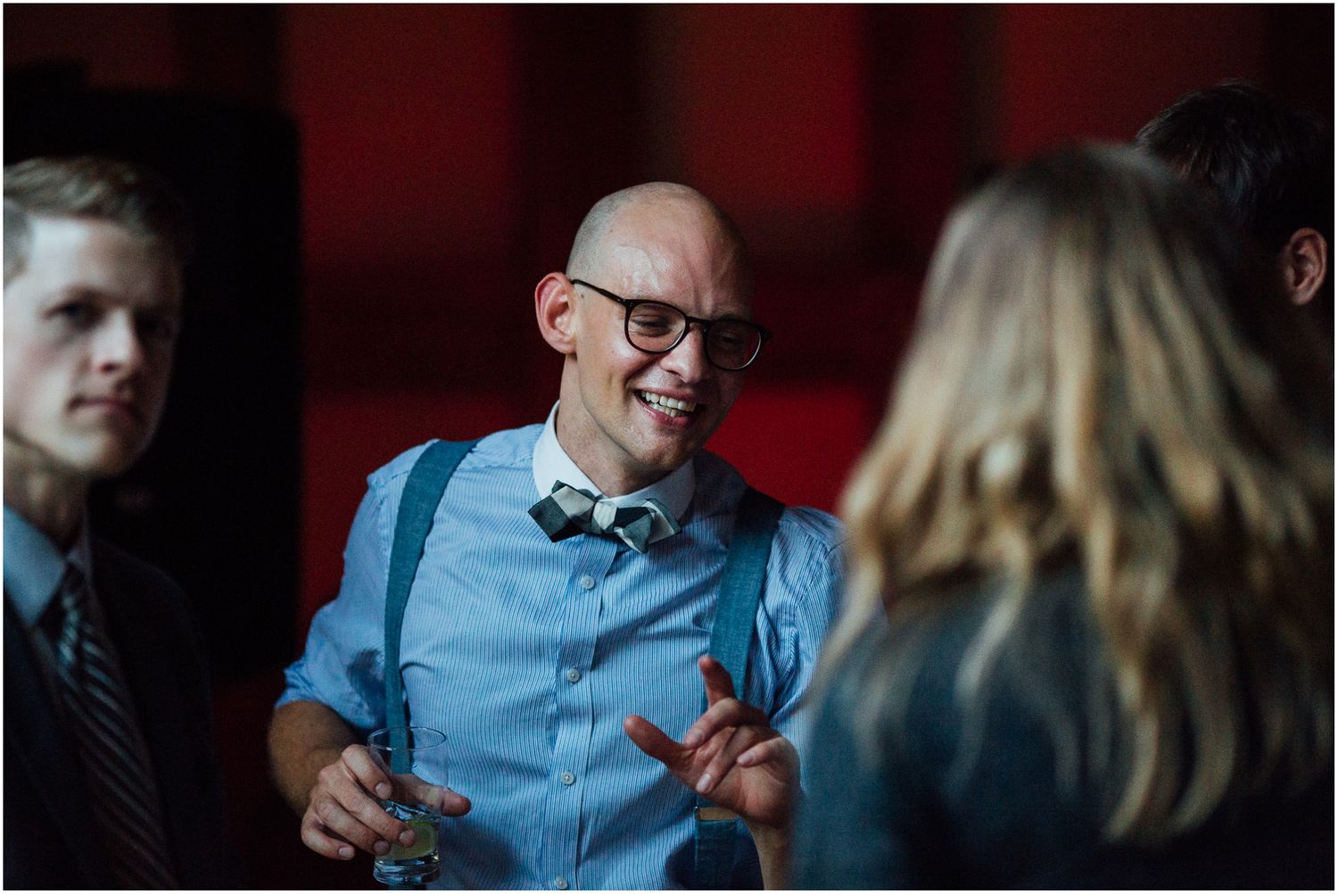 Guests enjoying conversation and drinks during an evening wedding reception.