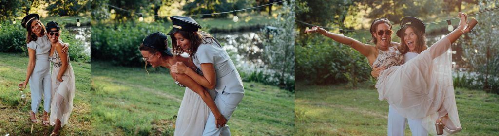 Guests mingle and dance during a sunny outdoor wedding celebration in a garden setting.