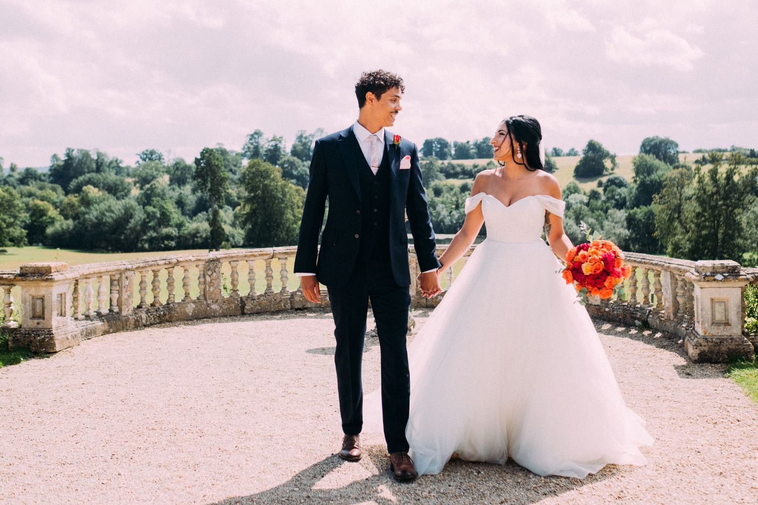 Romantic wedding photoshoot on stone terrace of historic estate.