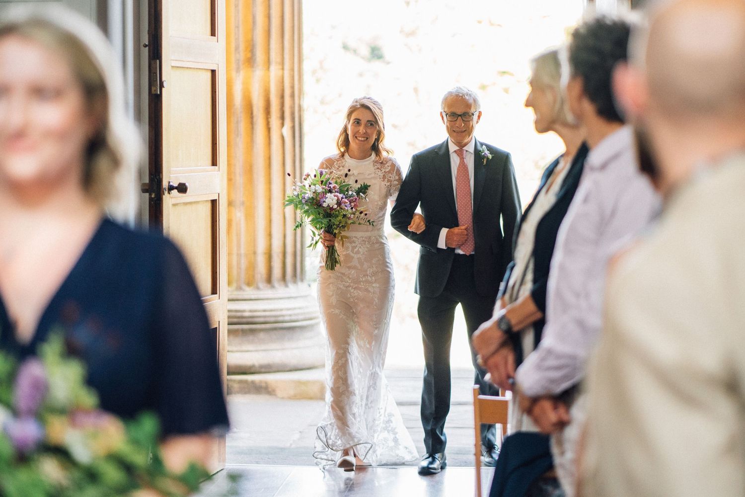 A series of candid wedding photos showing guests and the couple in an elegant indoor venue.