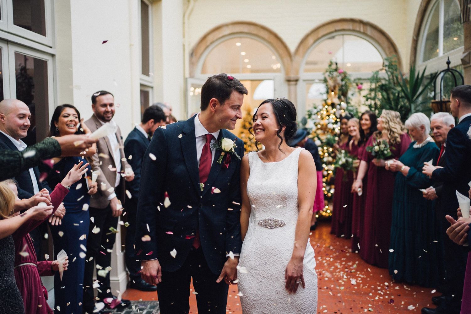 Elegant wedding ceremony setup in a historic venue with arched windows and classic decor.