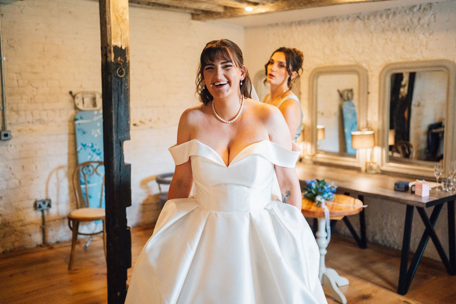 A sequence of candid wedding preparation moments showing brides and attendants getting ready in a rustic venue.