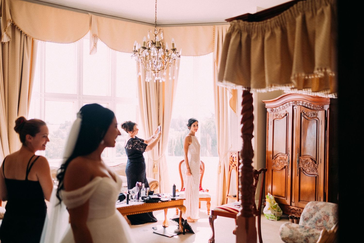 Elegant interior of wedding venue with chandeliers and classic furnishings.