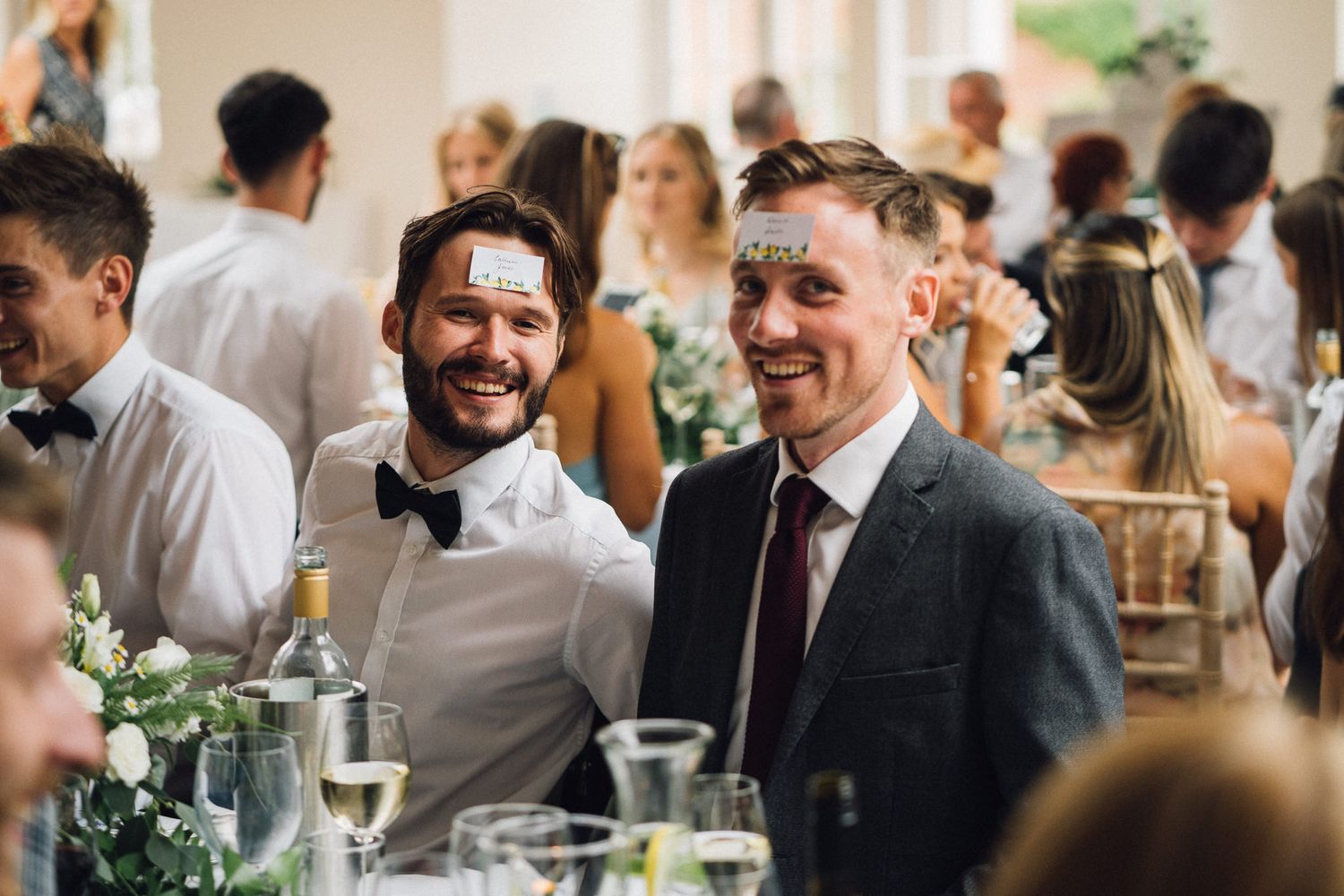 Wedding reception guests enjoying a lively celebration in a bright indoor venue.