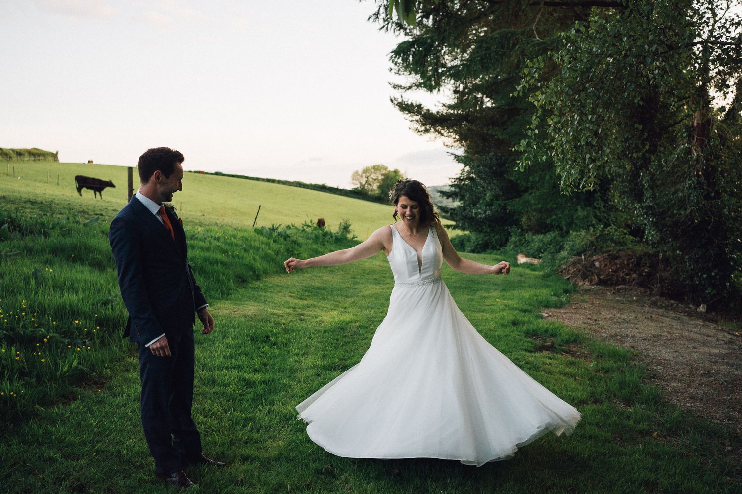Romantic outdoor wedding photoshoot in a pastoral countryside setting.