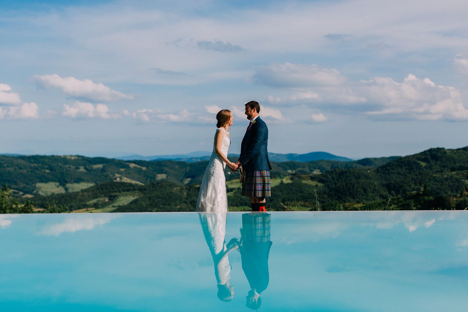 Scenic mountain views and infinity pools at a luxury resort with people enjoying the panoramic landscape.