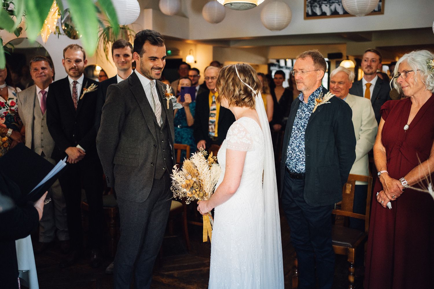 A collage of wedding reception moments showing dancing, embraces and celebrations in an indoor venue.