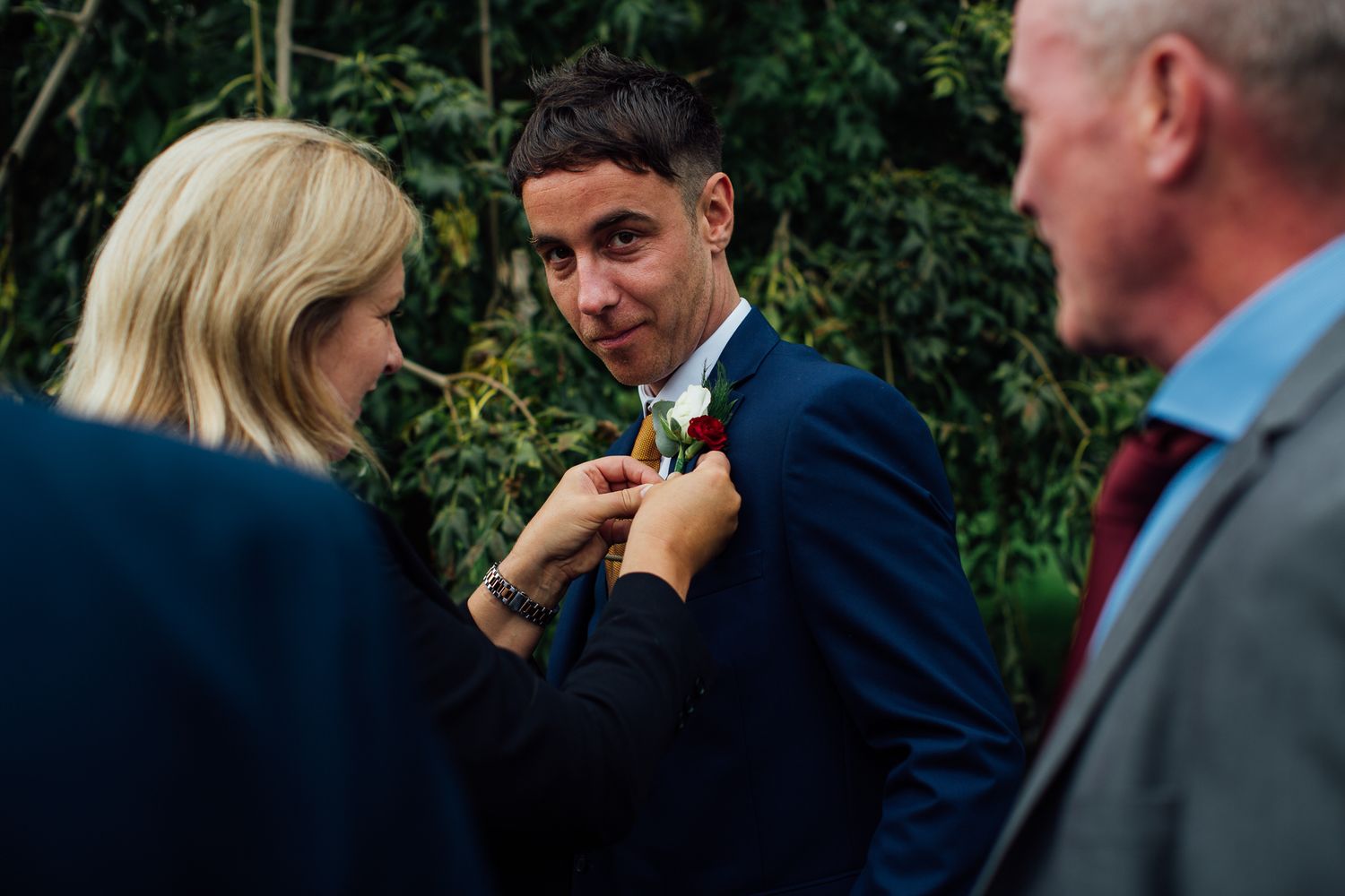 A series of candid moments at an outdoor event showing people in formal attire interacting and conversing.