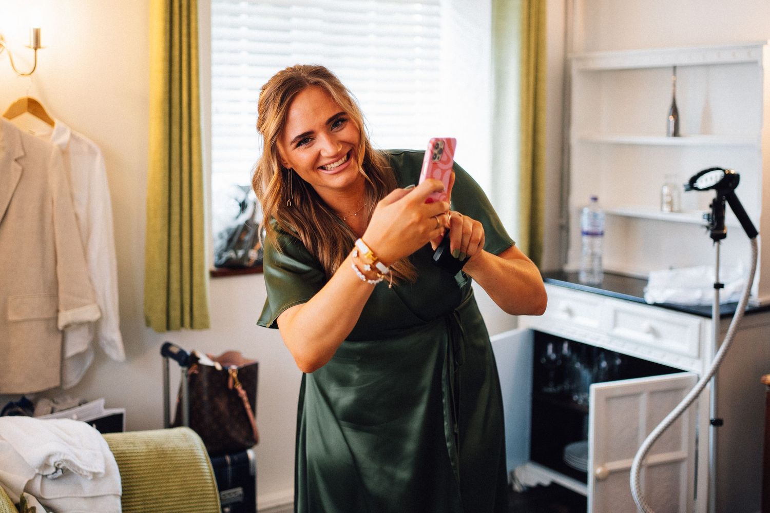 Candid behind-the-scenes moments captured during wedding preparations in a bright indoor setting.