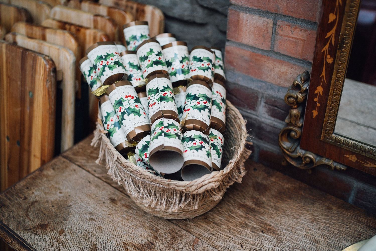 A basket filled with decorative white and turquoise ceramic coffee mugs on a rustic wooden table.