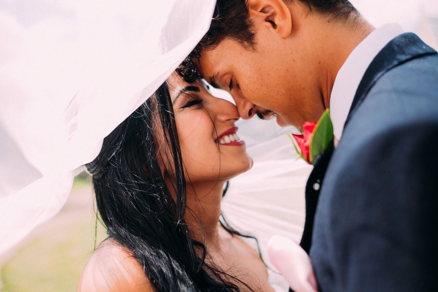 Close-up of couple sharing tender moment during wedding photoshoot.