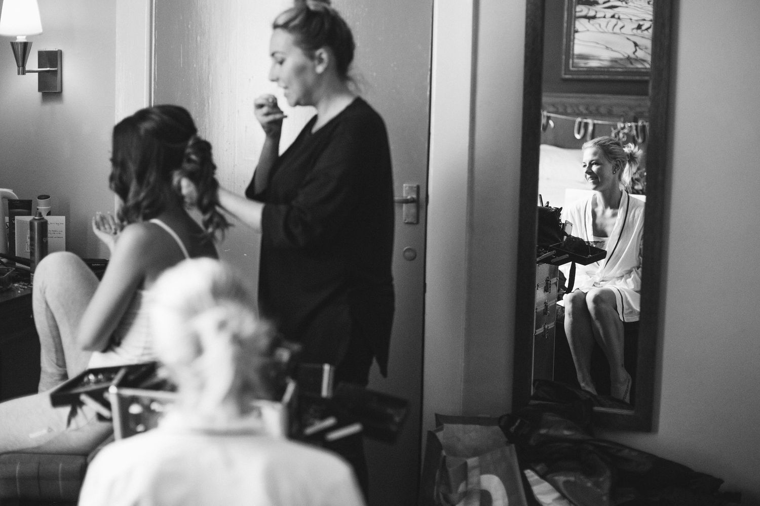 Wedding preparation moments captured in black and white photography.