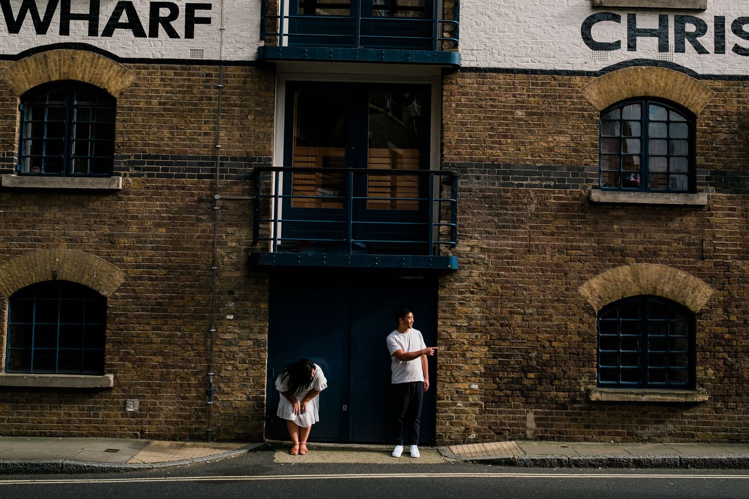 Historic brick buildings line a narrow street with rustic charm and vintage architecture.