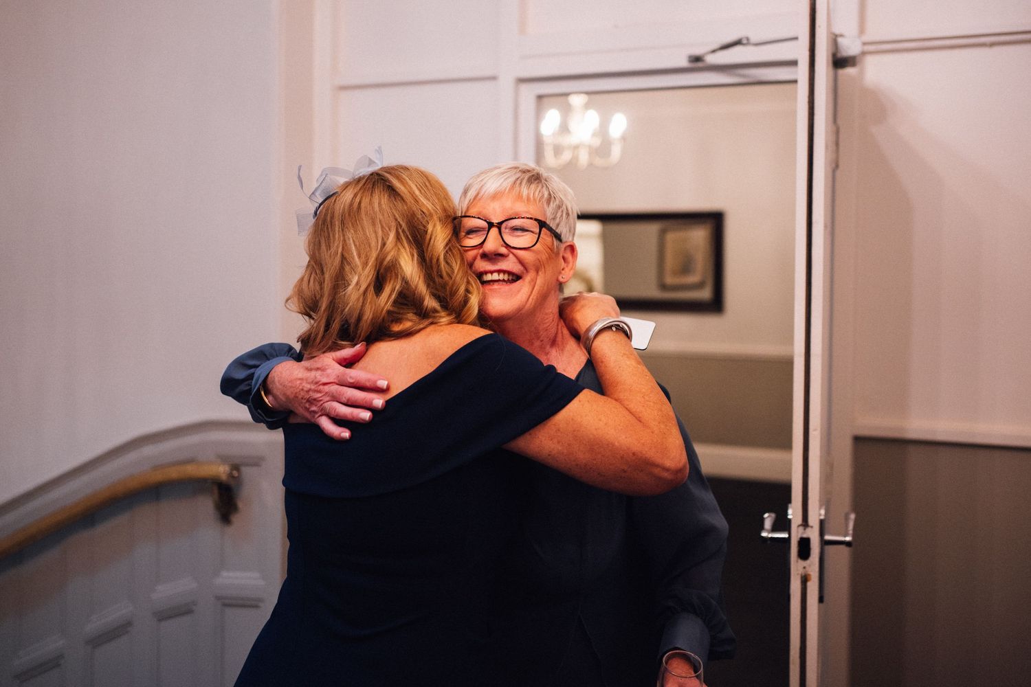 A series of tender moments captured during a wedding celebration in a bright indoor setting.
