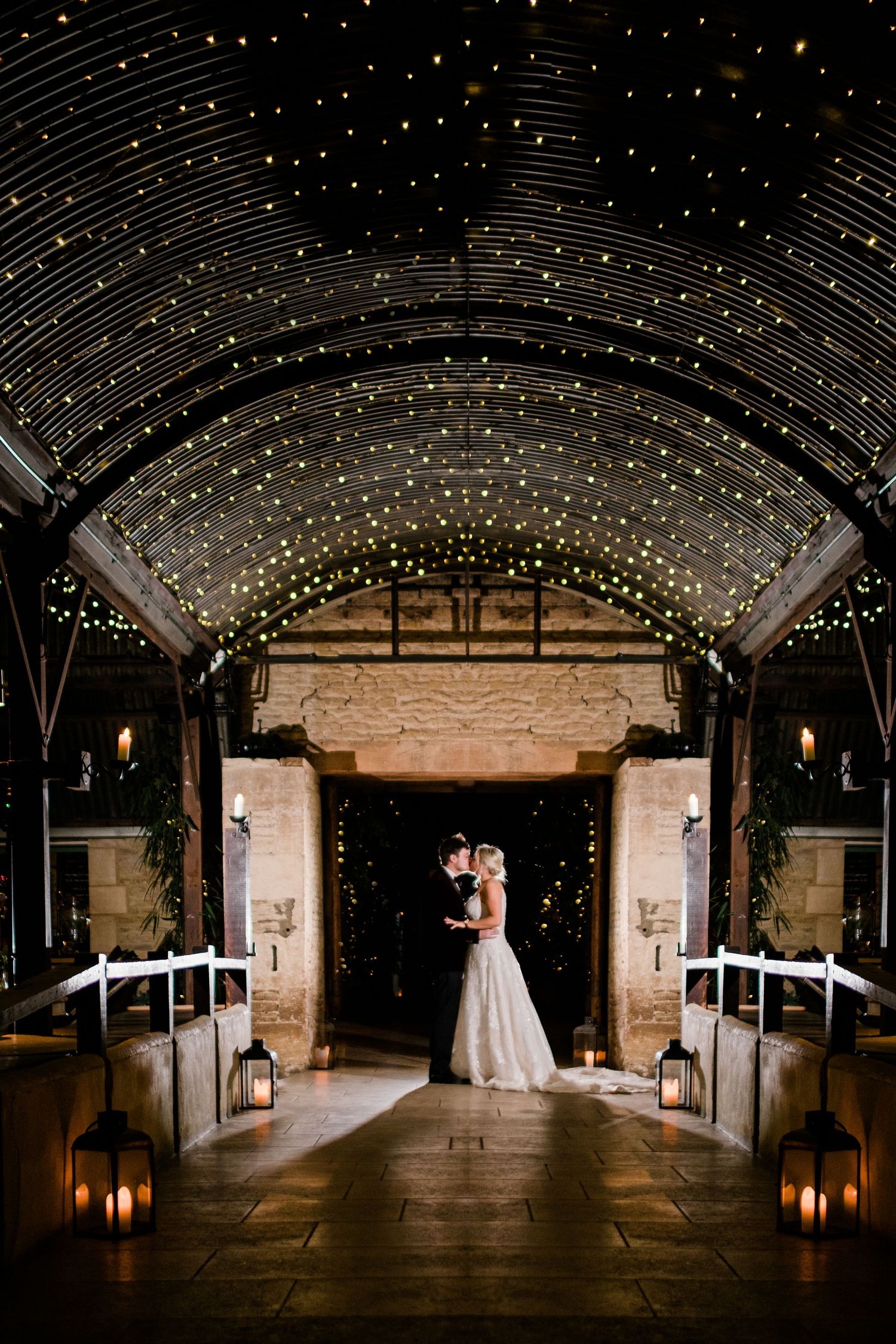 A panoramic sequence showing a romantic barn venue with twinkling lights and lanterns creating a magical wedding atmosphere.