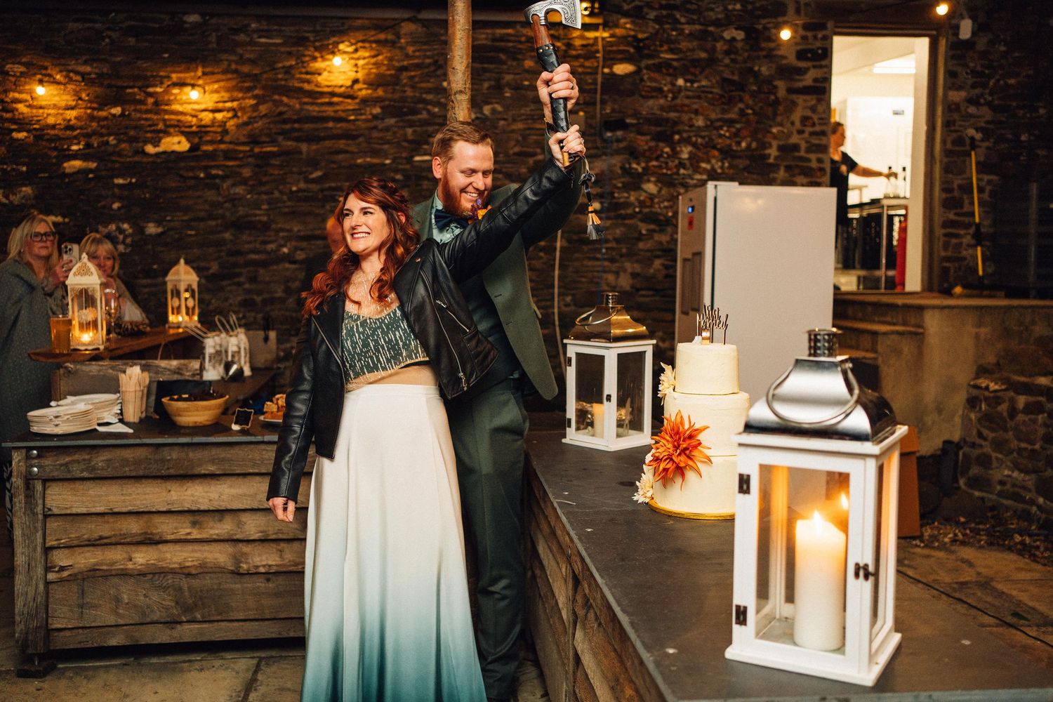Candlelit wedding reception venue with rustic stone walls and lantern decorations creating romantic ambiance.