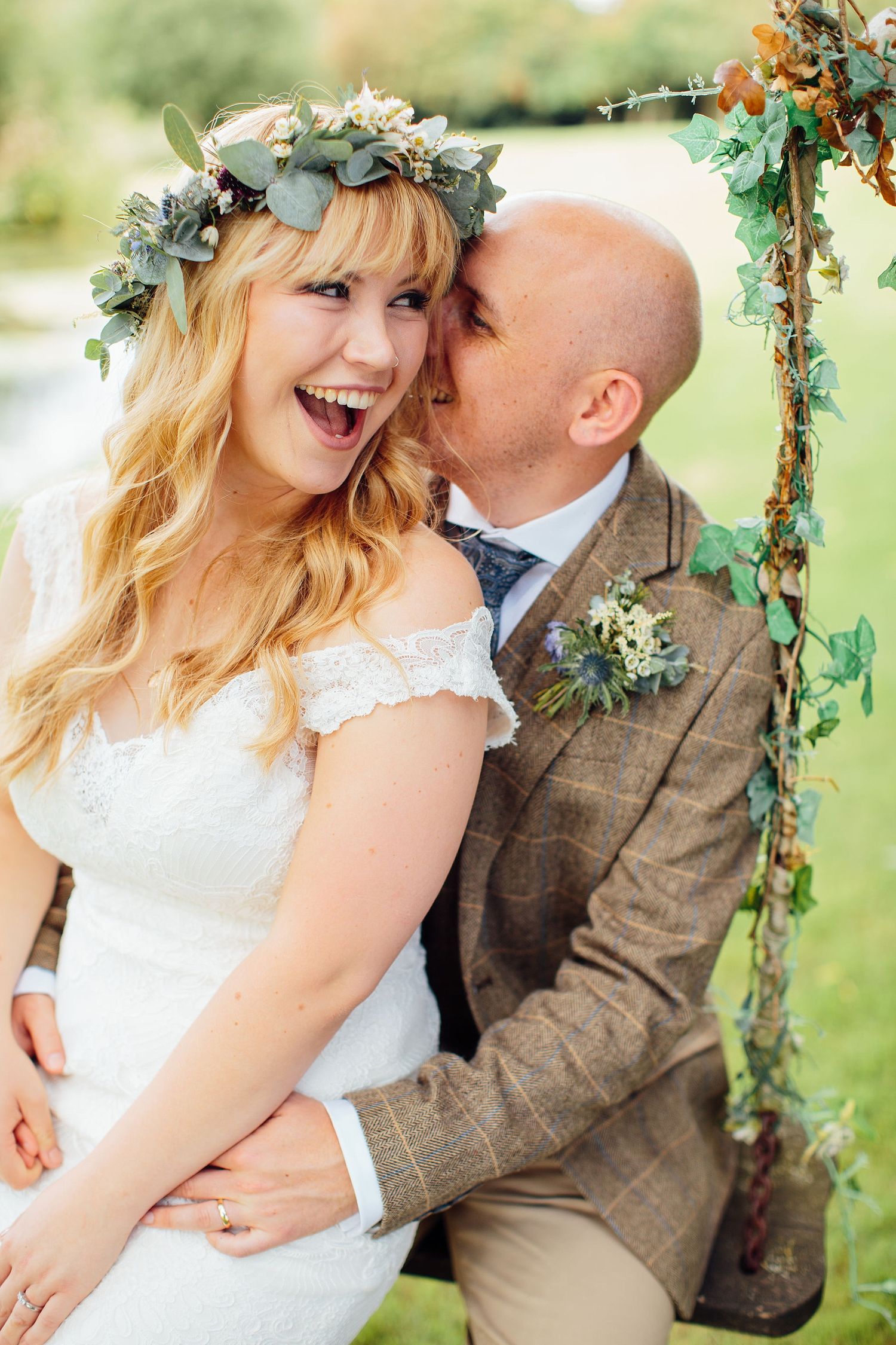 Romantic wedding portraits with floral arch and natural greenery backdrop.