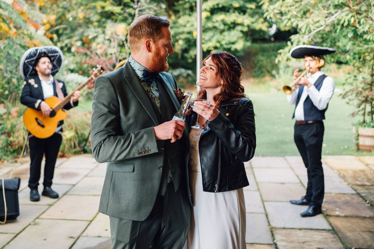 Candid moments captured at an outdoor wedding reception showing guests mingling and laughing together.