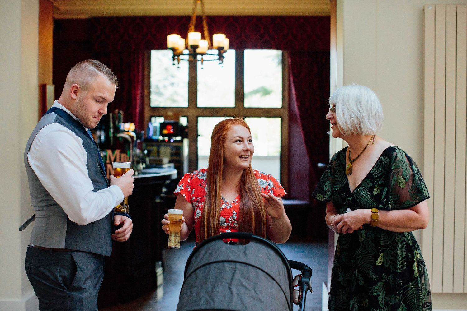 Wedding guests mingle and socialize during a reception in an elegant indoor venue.