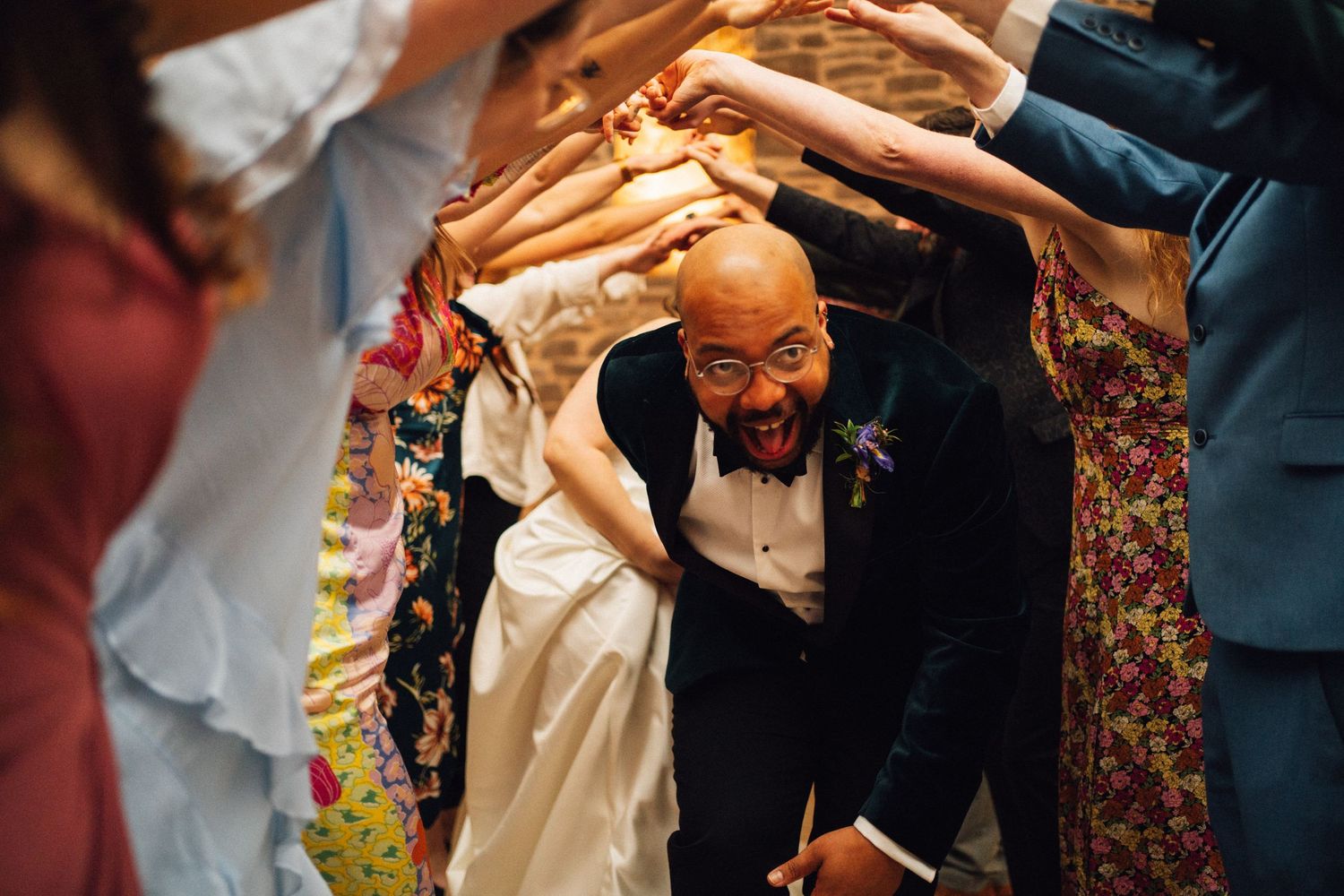 Wedding guests dance and celebrate together during a lively reception party.