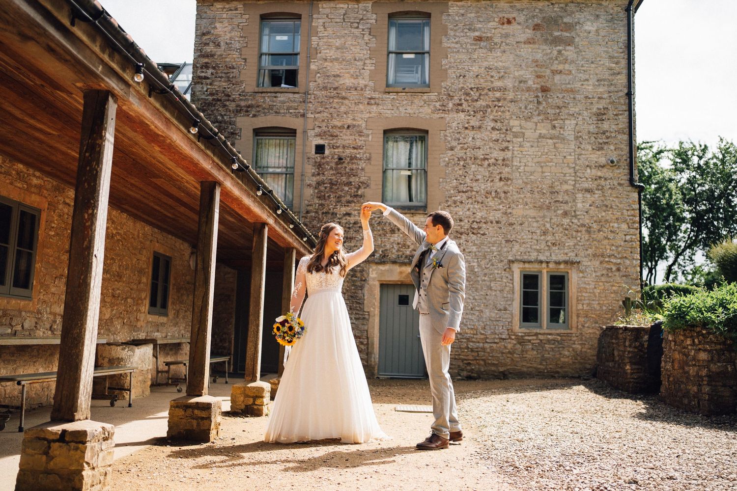 Historic stone building with rustic architecture serves as wedding venue backdrop.