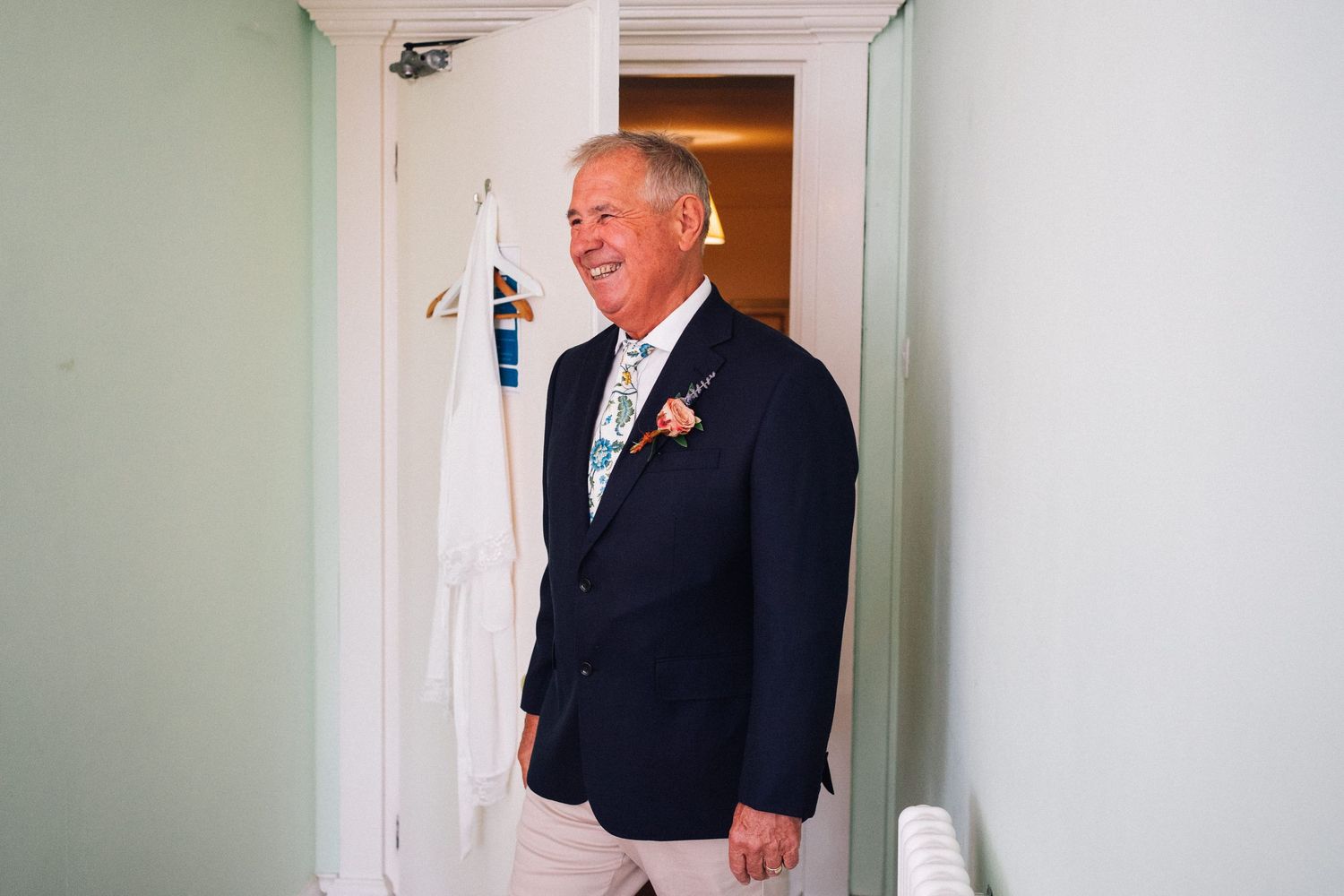 Wedding preparation moments captured in a bright hallway setting.