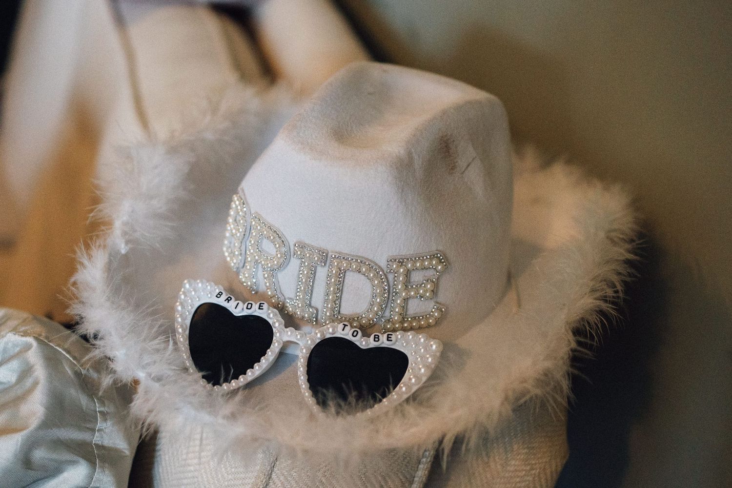 Close-up details of bridal accessories with delicate lace and sparkly embellishments.